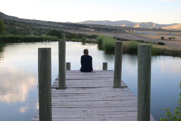 woman sitting on a pier