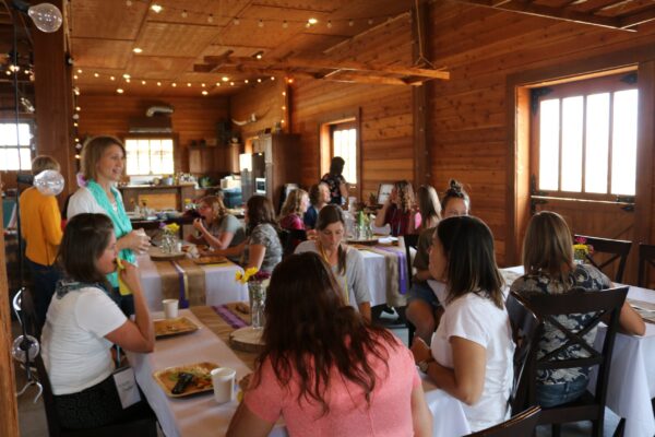 group of women at a retreat eating at several tables